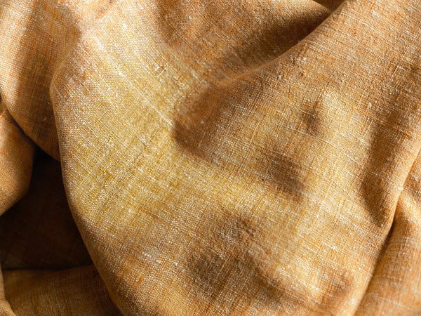 Scarf made from organic peace silk on a handloom in India. Eri silk scarf from India handspun and handwoven in a yellow color. Naturally dyed with the ayurvedic plant myrobalan. Organic and natural material, 100% peace silk. Slow and ethically made.  