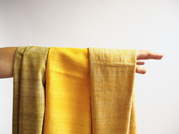 Scarf made from organic peace silk on a handloom in India. Eri silk scarf from India handspun and handwoven in a warm yellow color. Naturally dyed with the jackfruit bark. Organic and natural material, 100% peace silk. Slow and ethically made.  