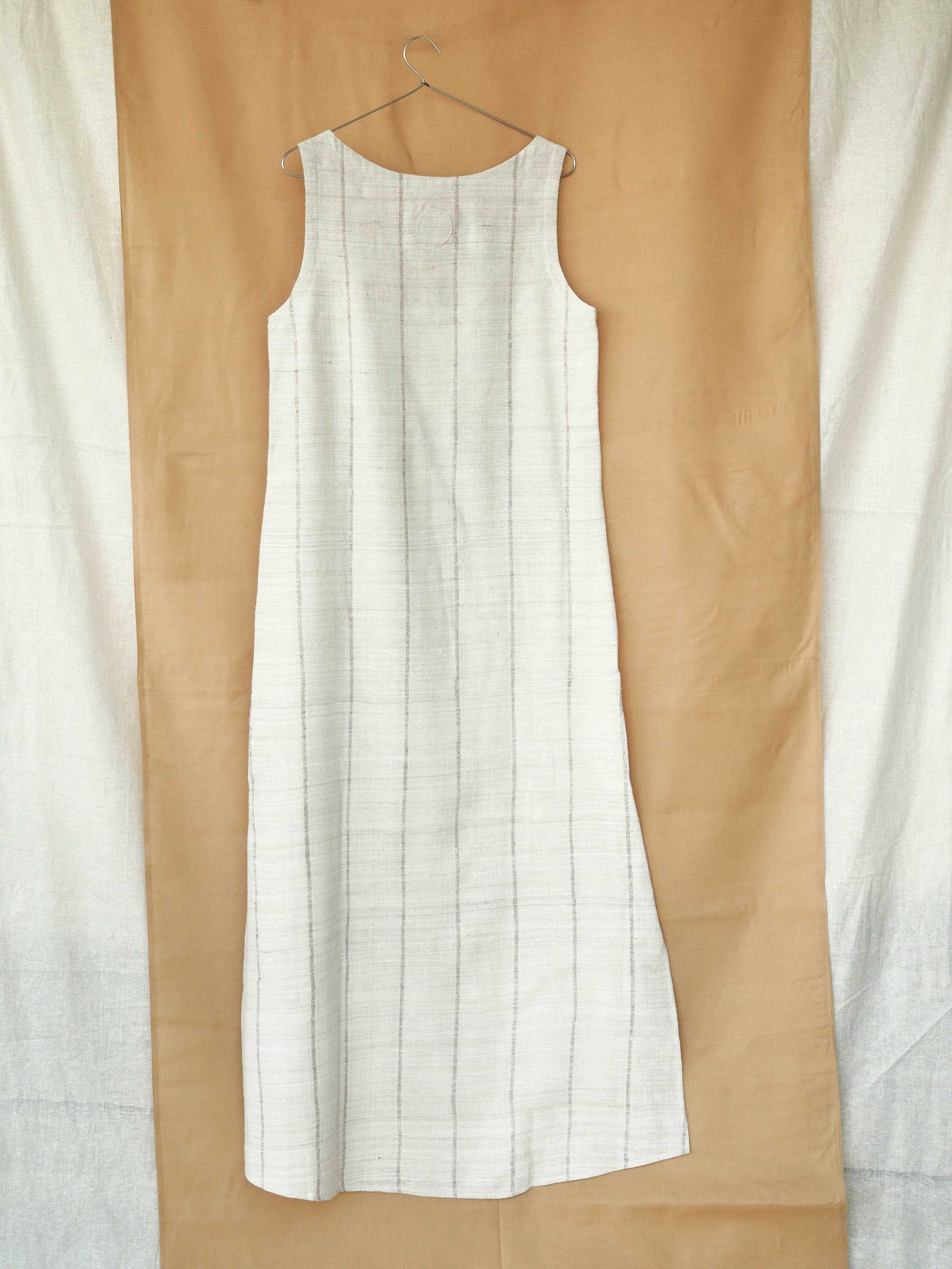 Handspun and handwoven eri silk dress in a cream color with beige stripes. Naturally dyed with teak leaves. 100% natural fiber. Ethically made, slow fashion.