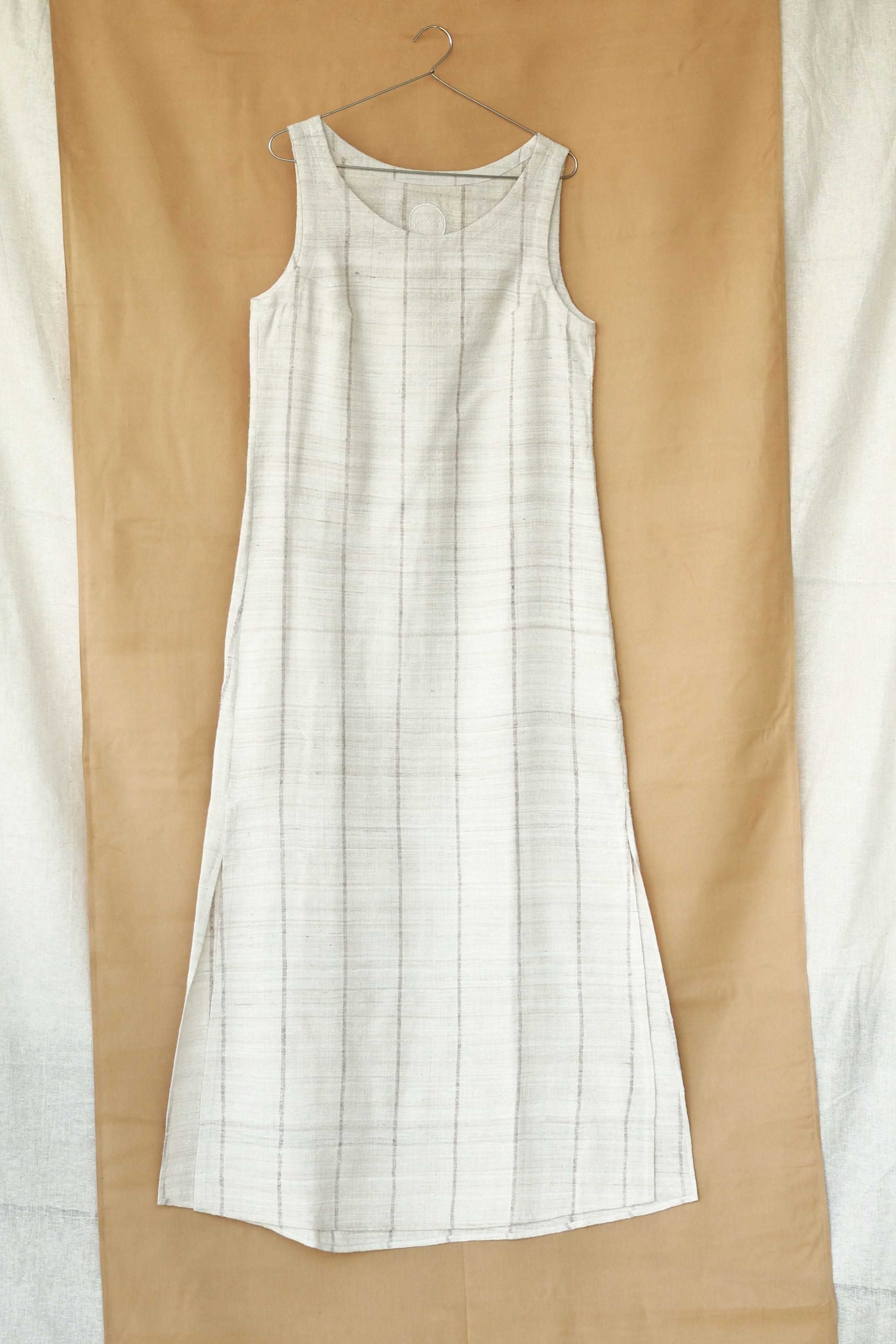 Handspun and handwoven eri silk dress in a cream color with beige stripes. Naturally dyed with teak leaves. 100% natural fiber. Ethically made, slow fashion.